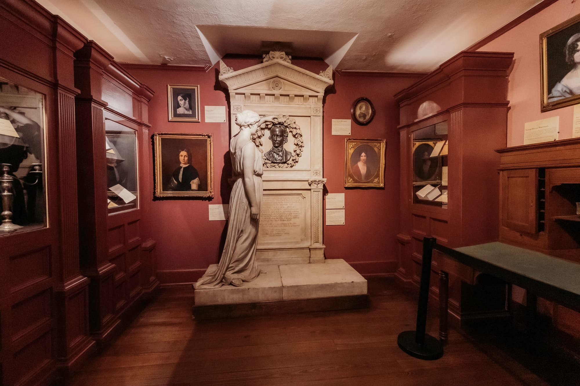 Edgar Allan Poe memorial statue and portraits inside the Poe Museum Richmond